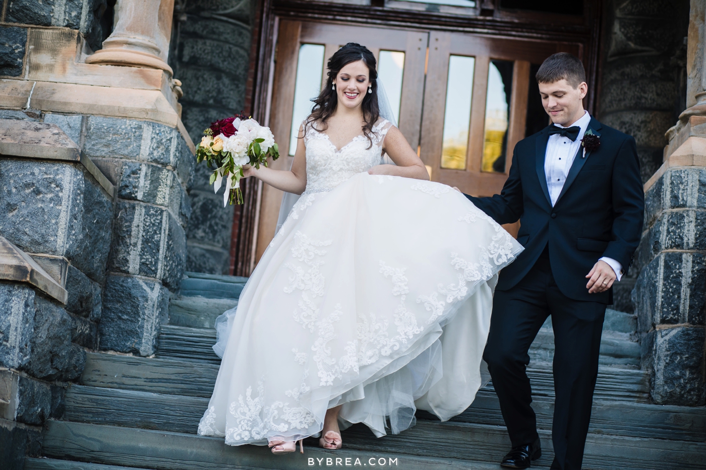 Dahlgren Chapel wedding groom helping bride down stairs