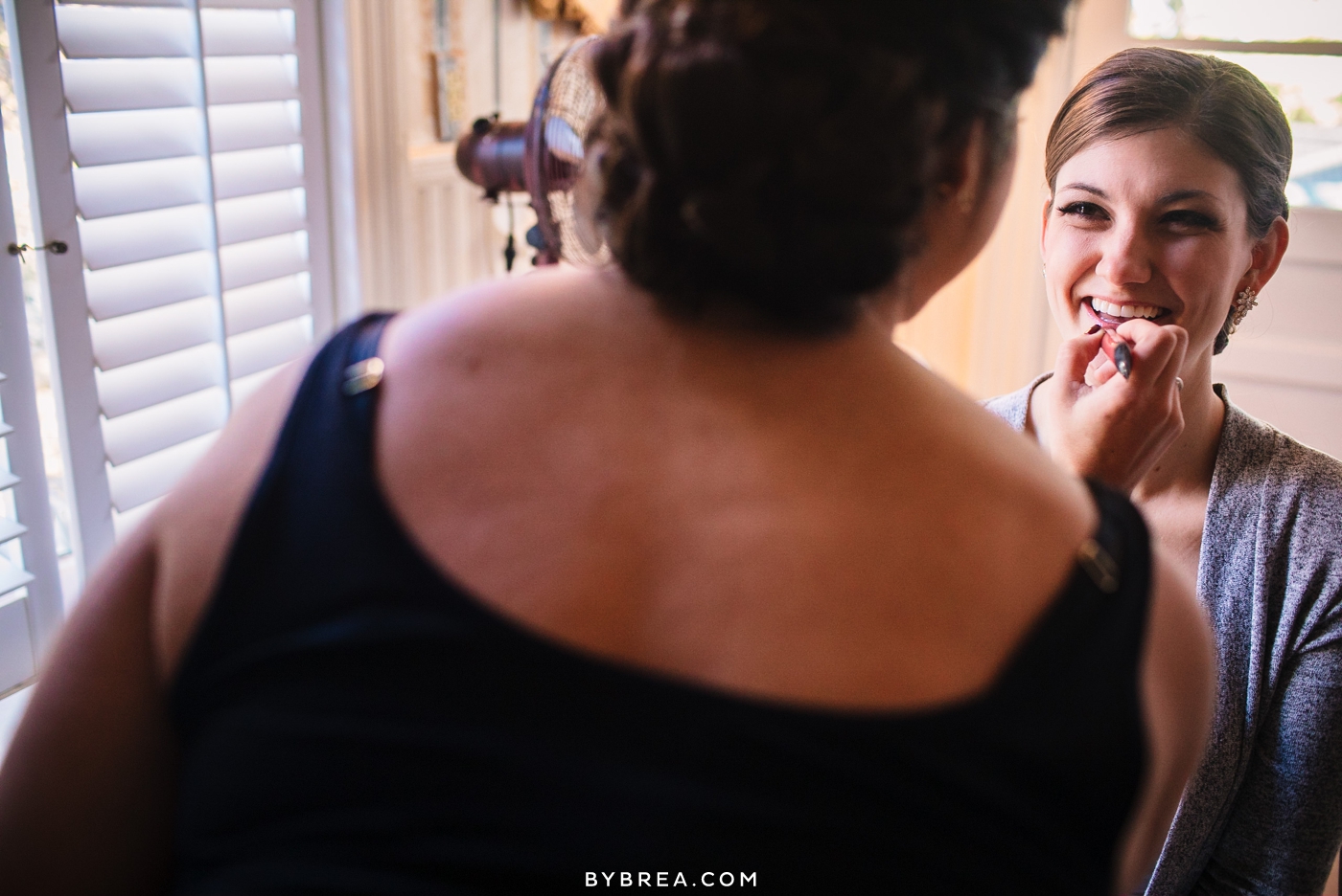 Vandiver Inn wedding Abby de Rosset applying lipstick to bride