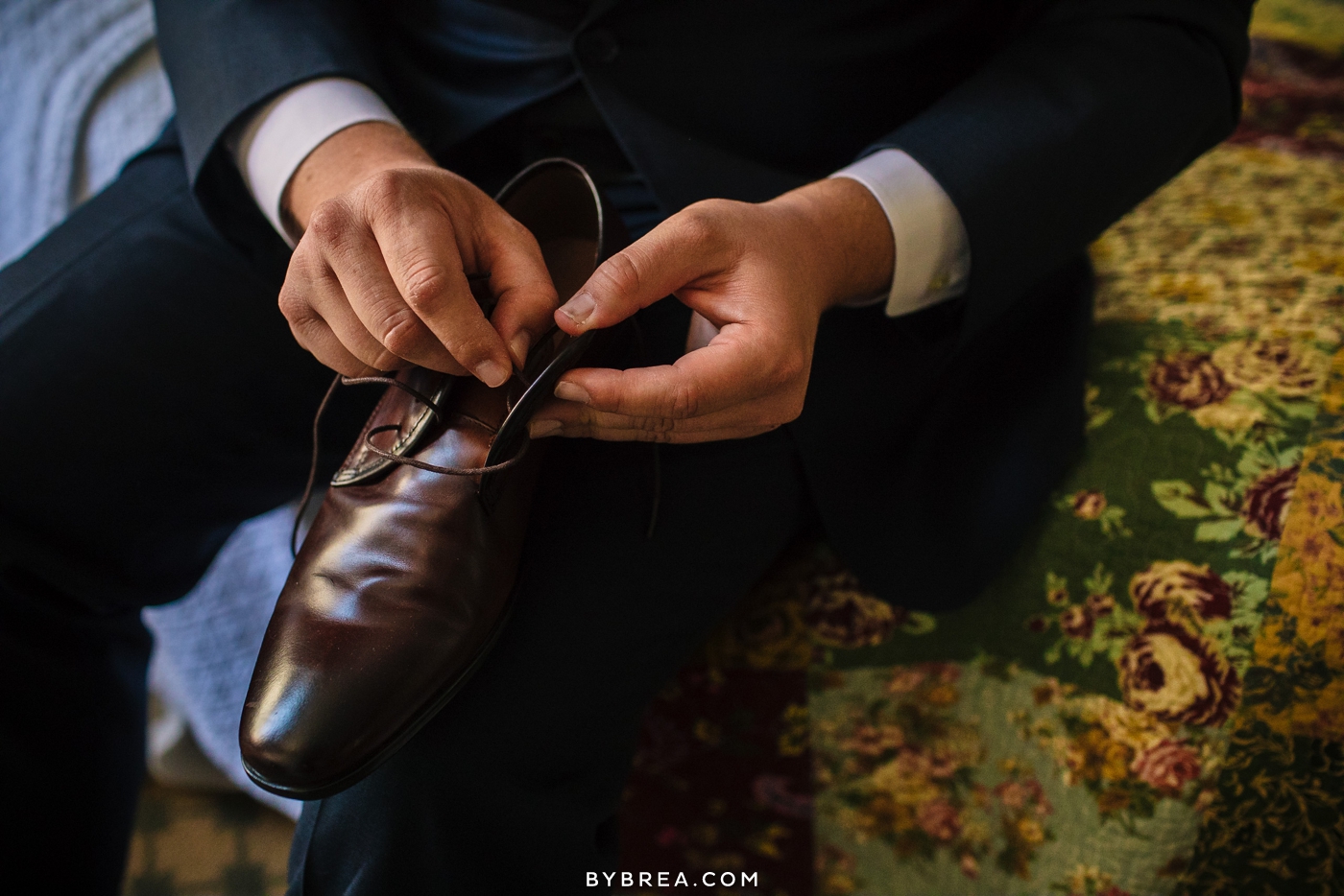 Vandiver Inn wedding groom lacing brown leather shoes