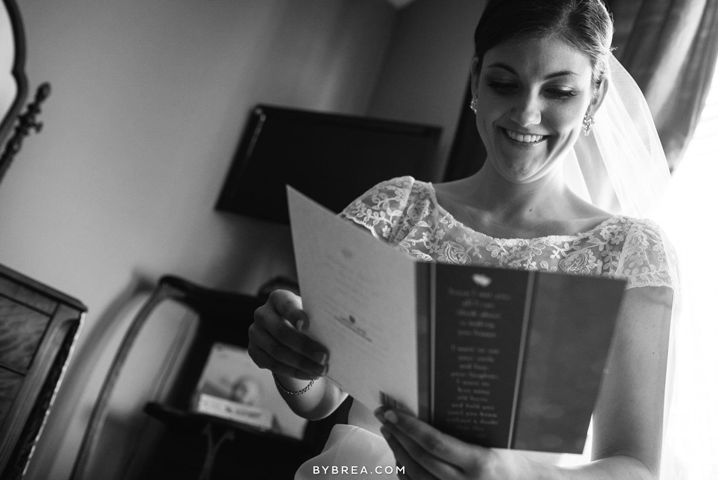 Vandiver Inn wedding bride wearing veil reading card from groom