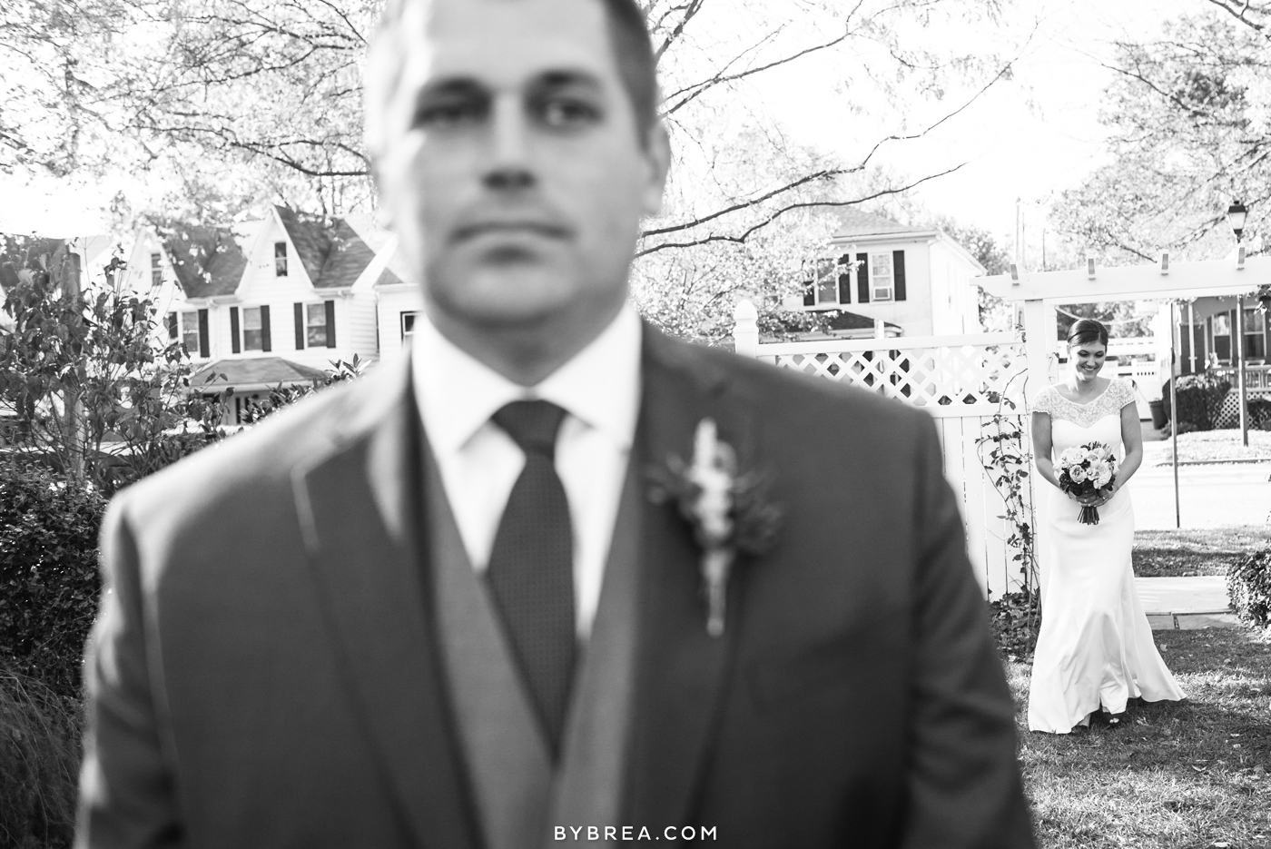 Baltimore wedding photo bride walking up behind groom for first look