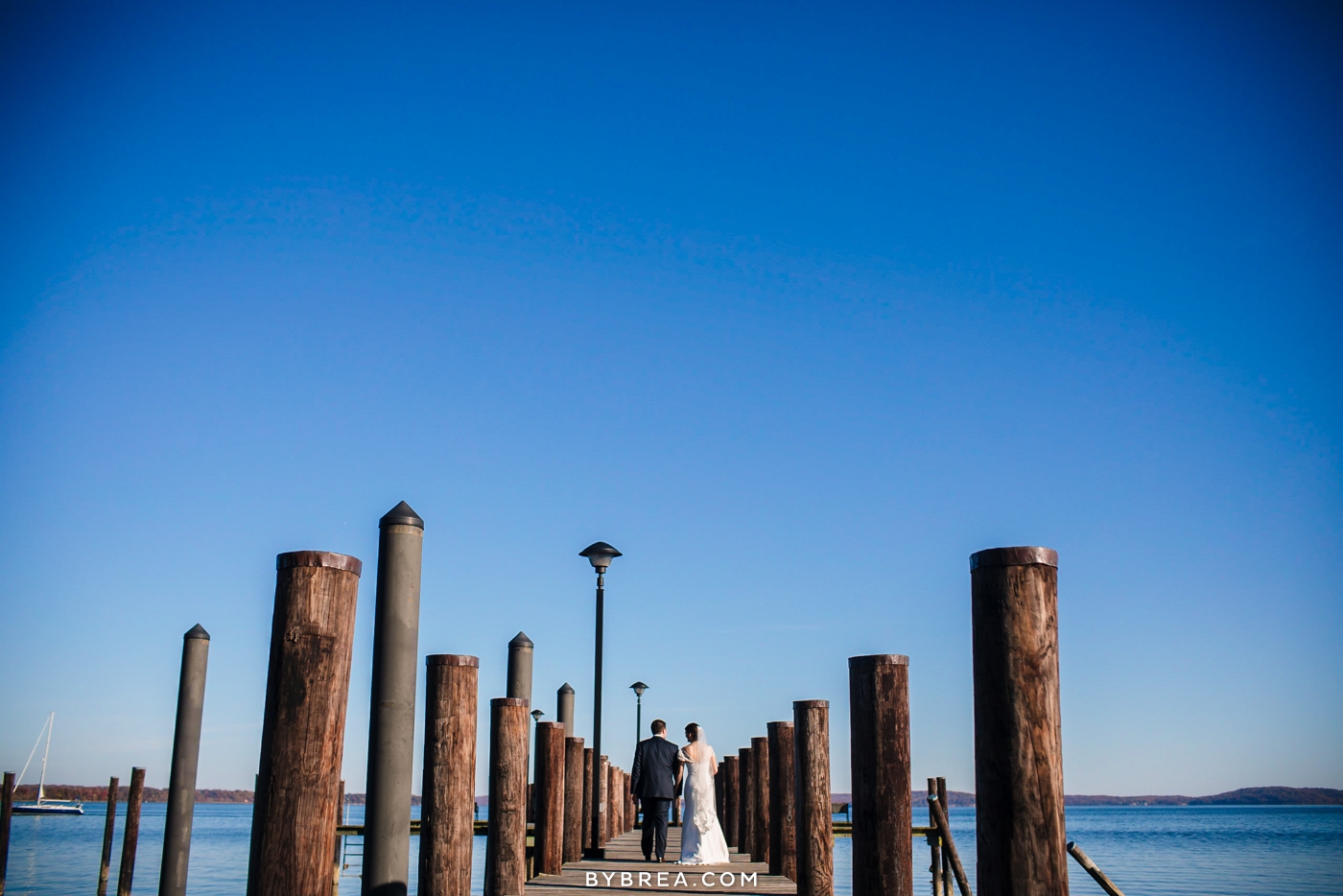 Vandiver Inn wedding bride and groom on pier bright blue sky