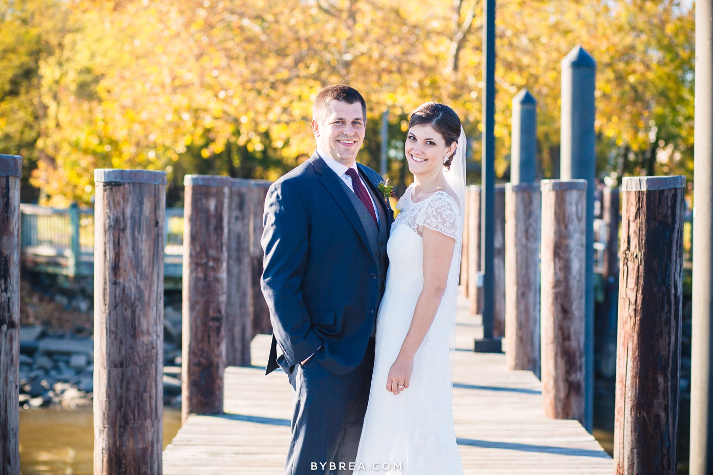 Vandiver Inn wedding bride and groom with fall foliage on pier