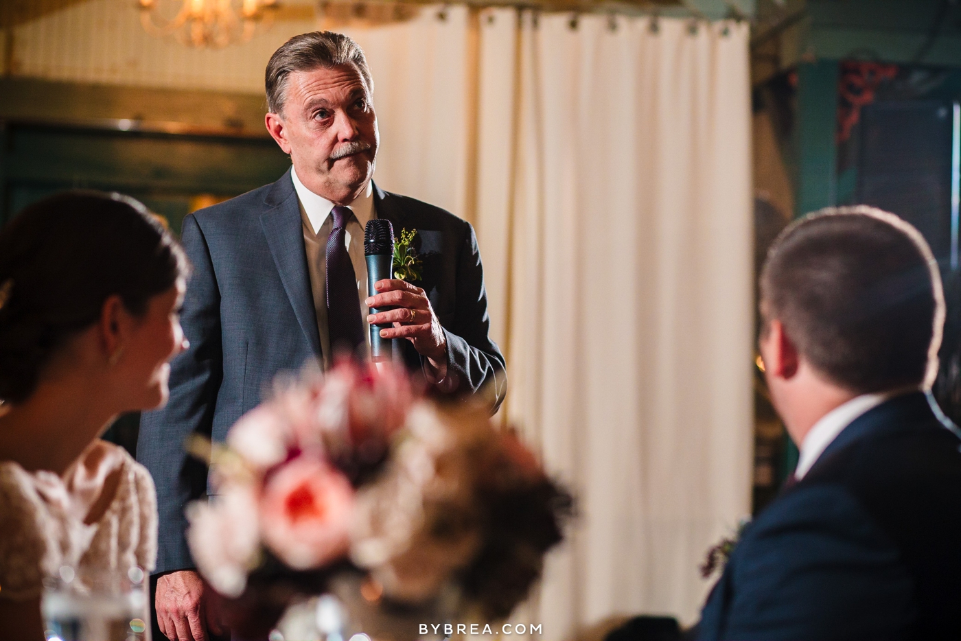 Vandiver Inn wedding man holds mic giving speech during dinner