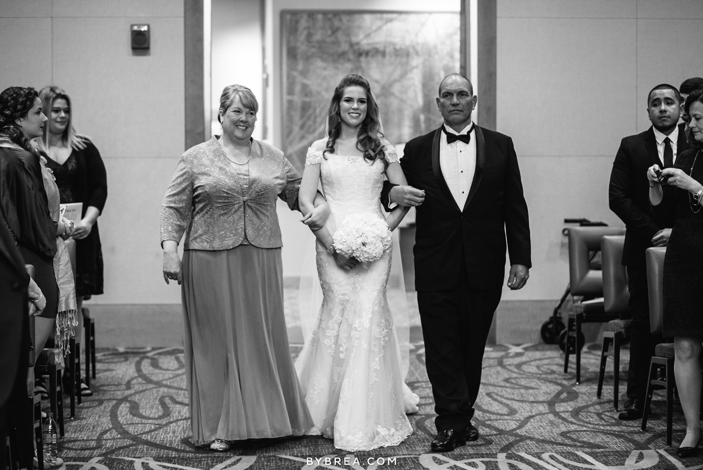 Hotel at Arundel Preserve wedding photo bride walking down aisle with family