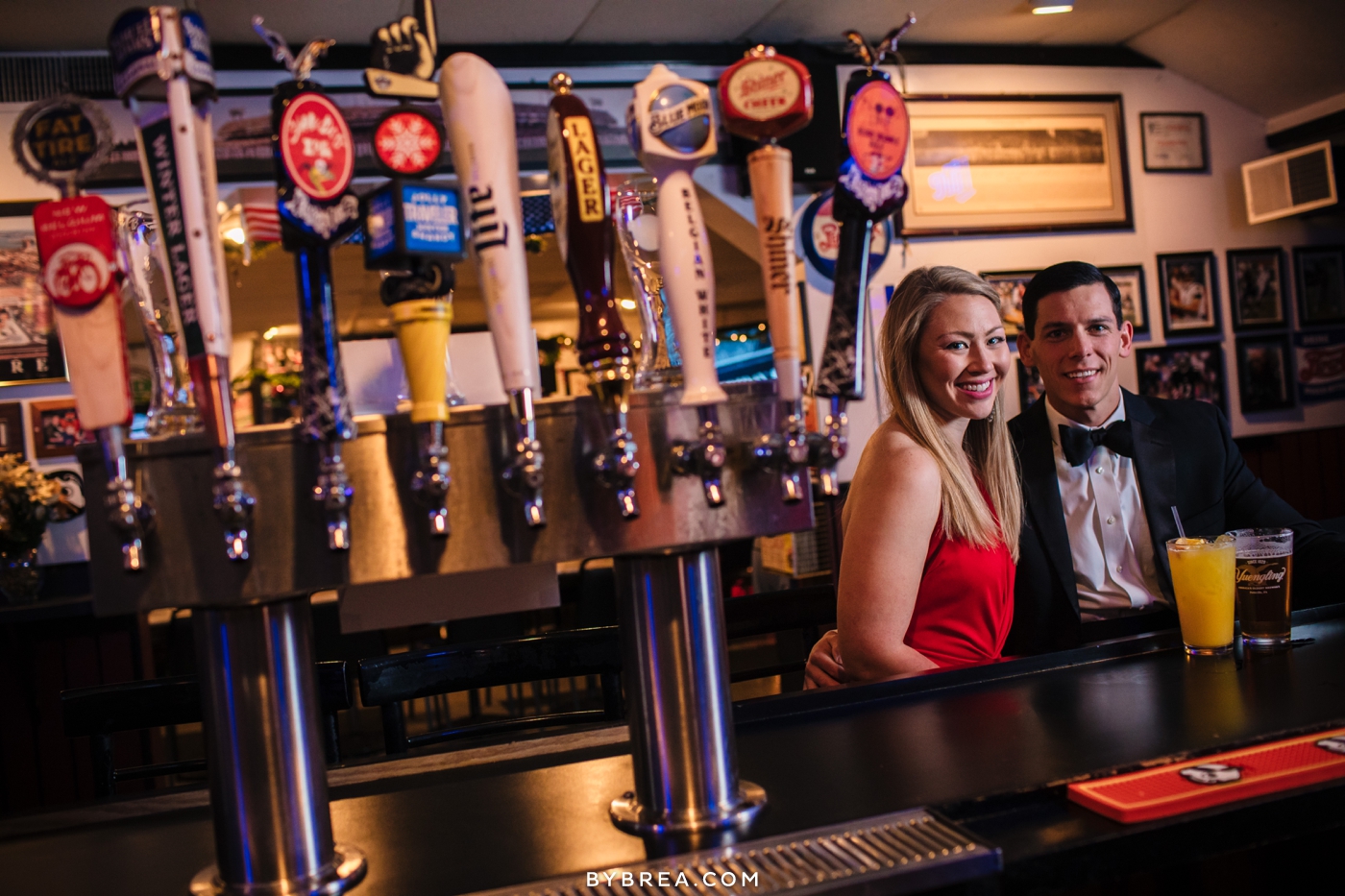 Christmas themed engagement photo beer taps sports bar fancy couple