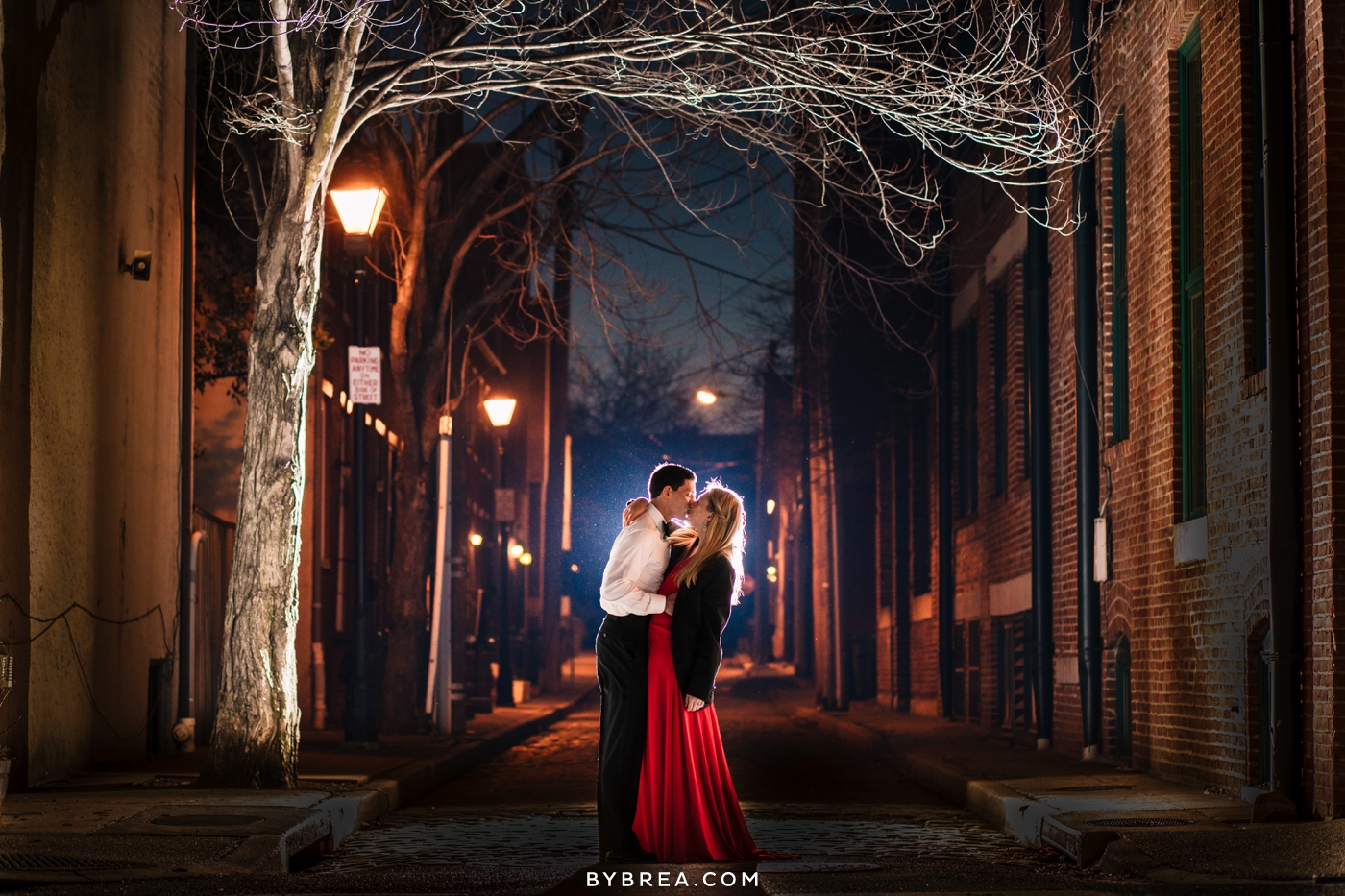 Christmas themed engagement session photo fancy couple kissing at night portrait