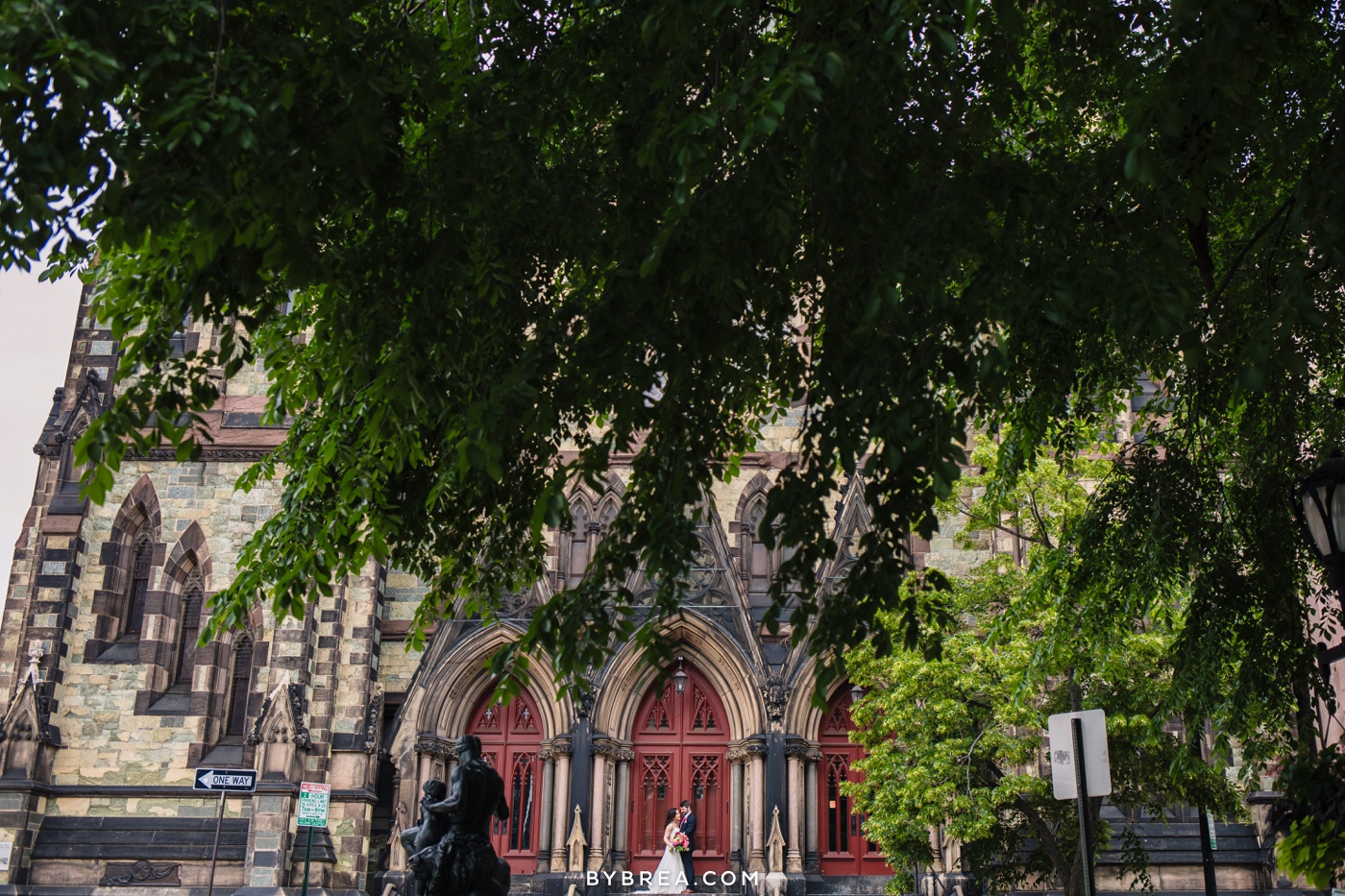 Baltimore wedding photo couple outside red cathedral doors