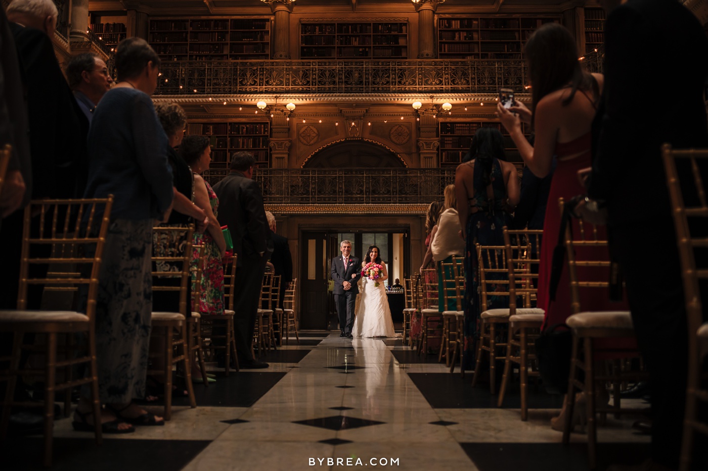 George Peabody Library wedding photo bride entering while guests stand