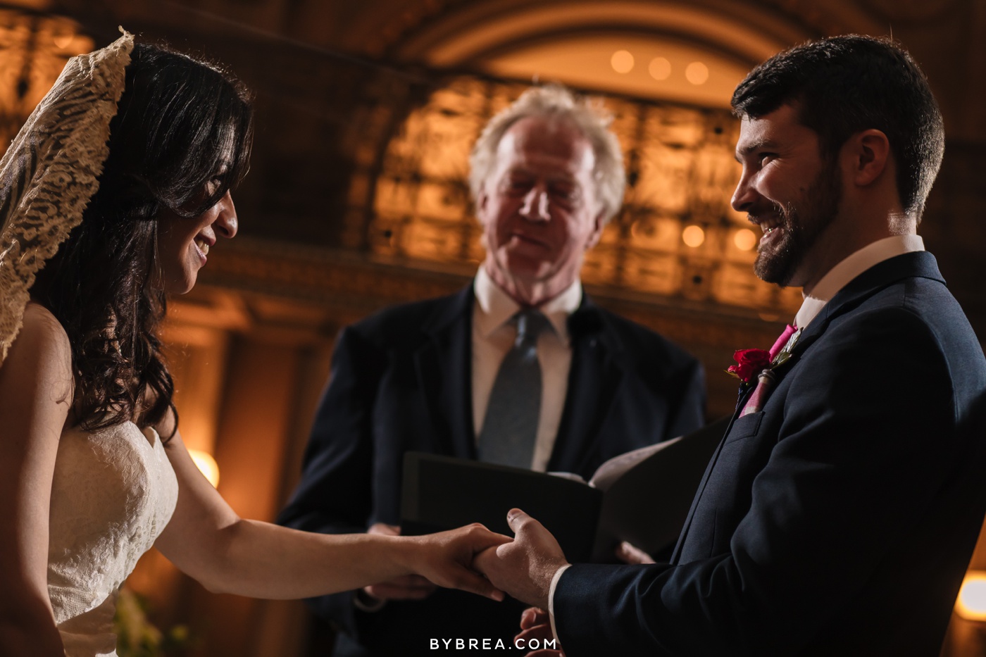 George Peabody Library wedding photo bride and groom exchanging rings