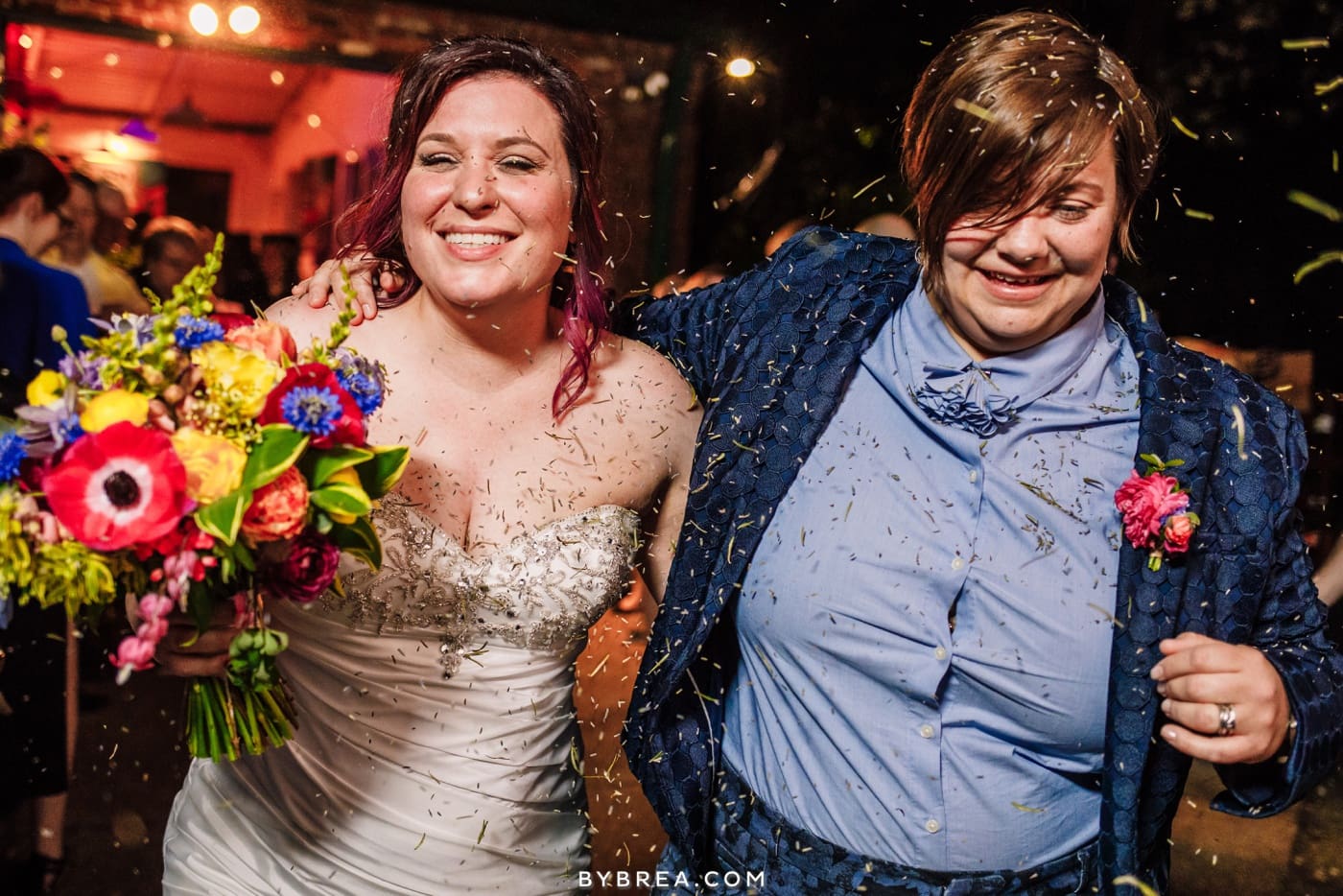 photograph of brides exiting wedding lavender toss same sex wedding photos