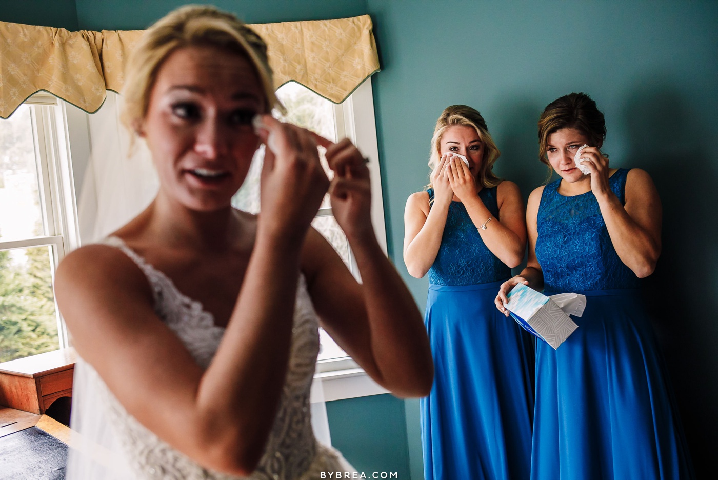 Emotional photo of bridesmaids and bride tearing up during getting ready Baltimore wedding photography