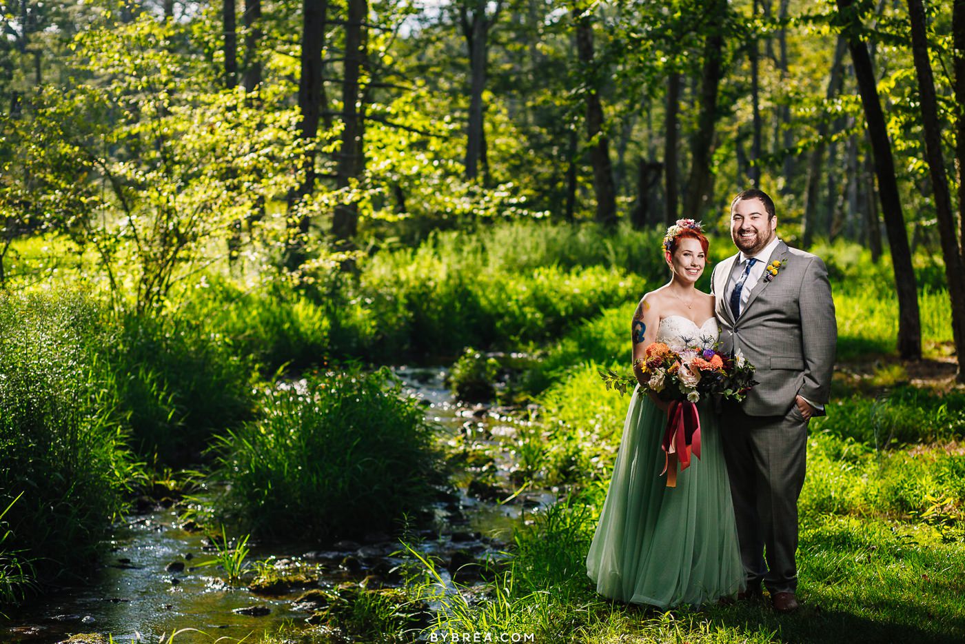 Portrait by creek at Caboose Farm Wedding