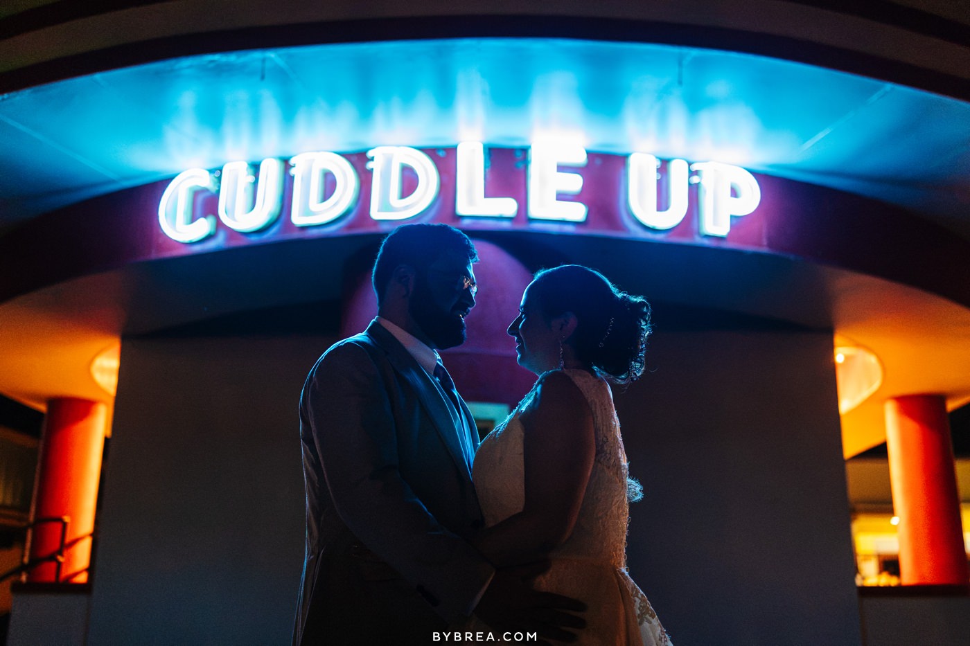 Glen Echo Park wedding photo of bride and groom at night with neon sign