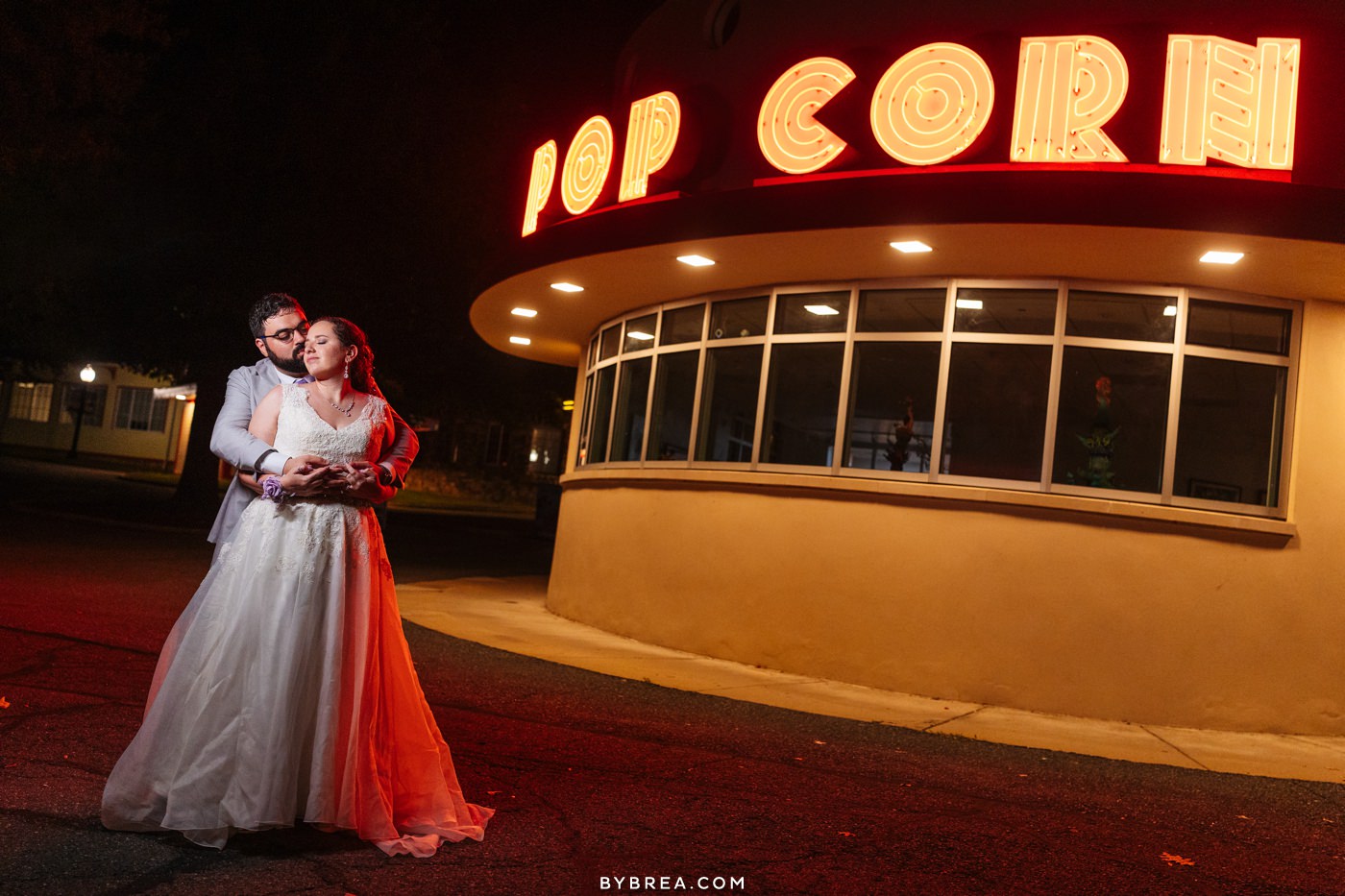 Glen Echo Park wedding photo of bride and groom at night with neon sign